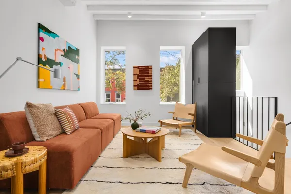 a living room with furniture and painting on the wall