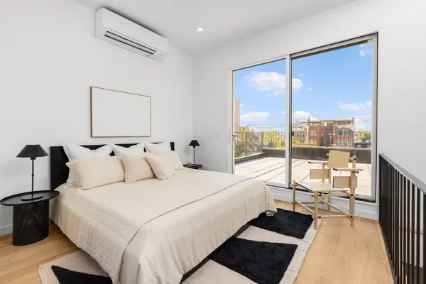 a large bedroom with a bed and glass window