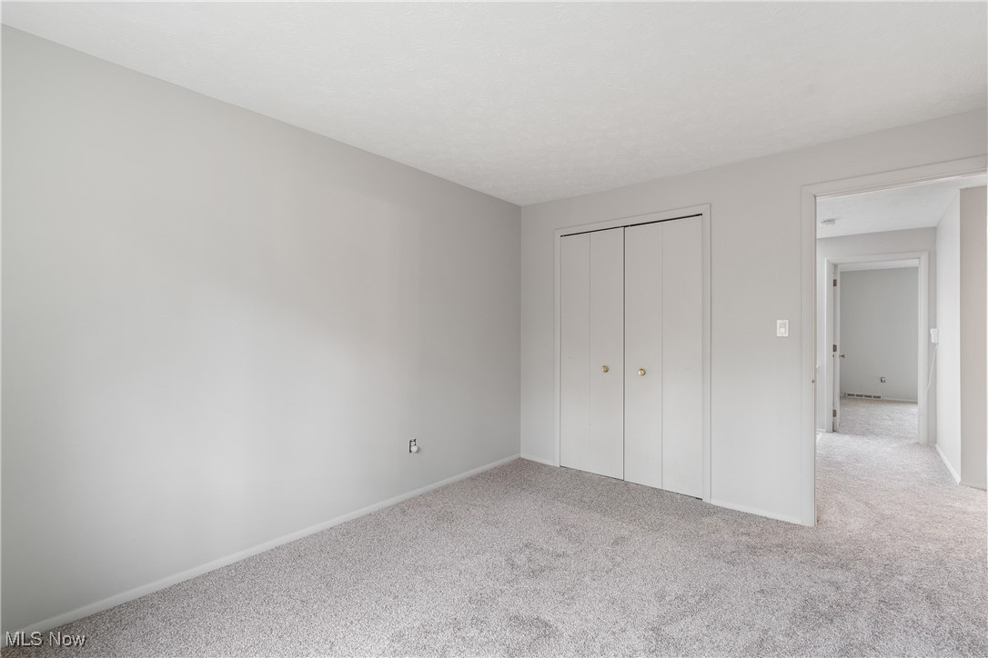 6462 State Road, Unit 4 Parma, OH 44134 - Photo 33 of 42 Unfurnished bedroom featuring carpet floors, a closet, and baseboards