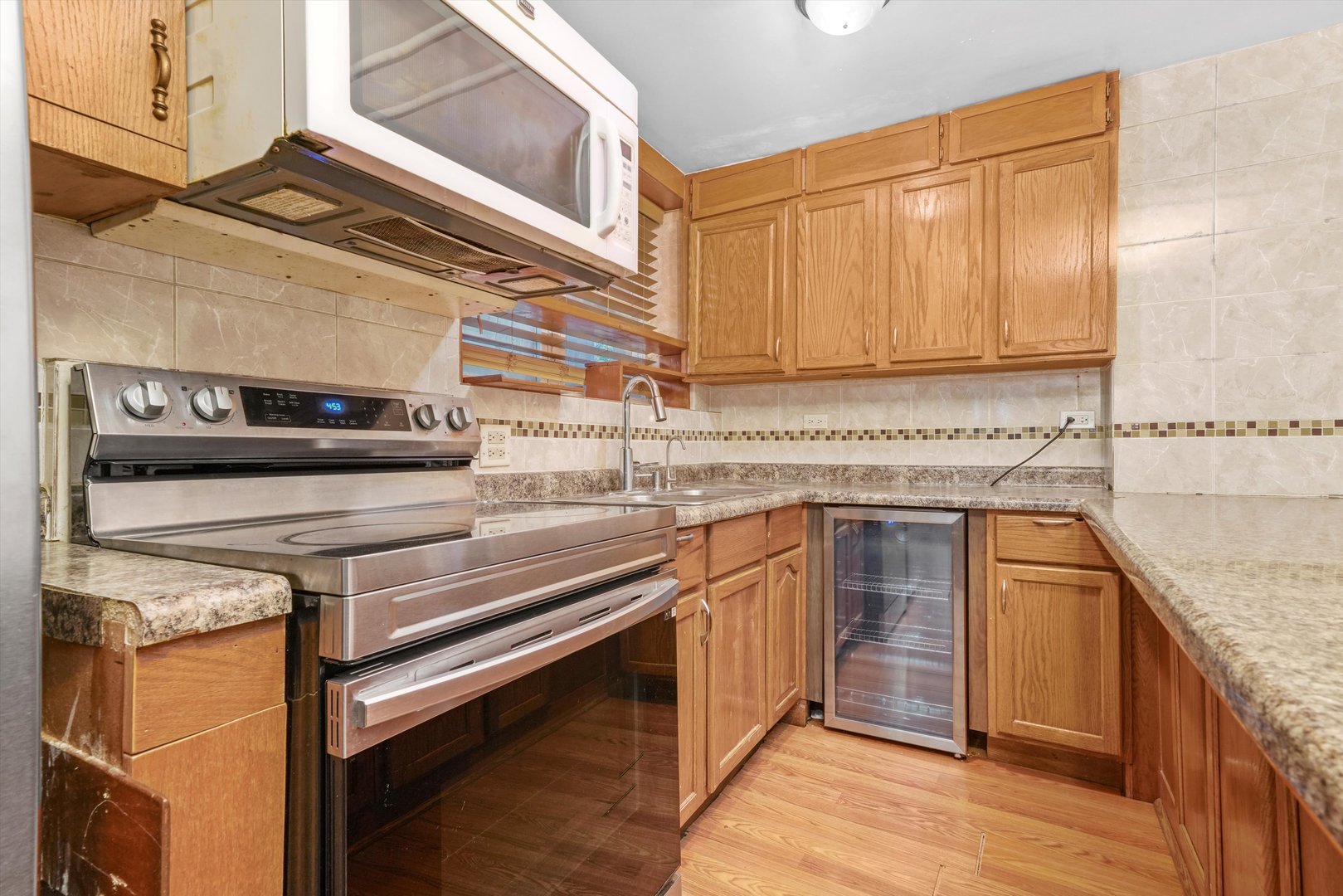1450 North Springfield Avenue Chicago, IL 60651 - Photo 16 of 46 a kitchen with stainless steel appliances granite countertop a sink and cabinets