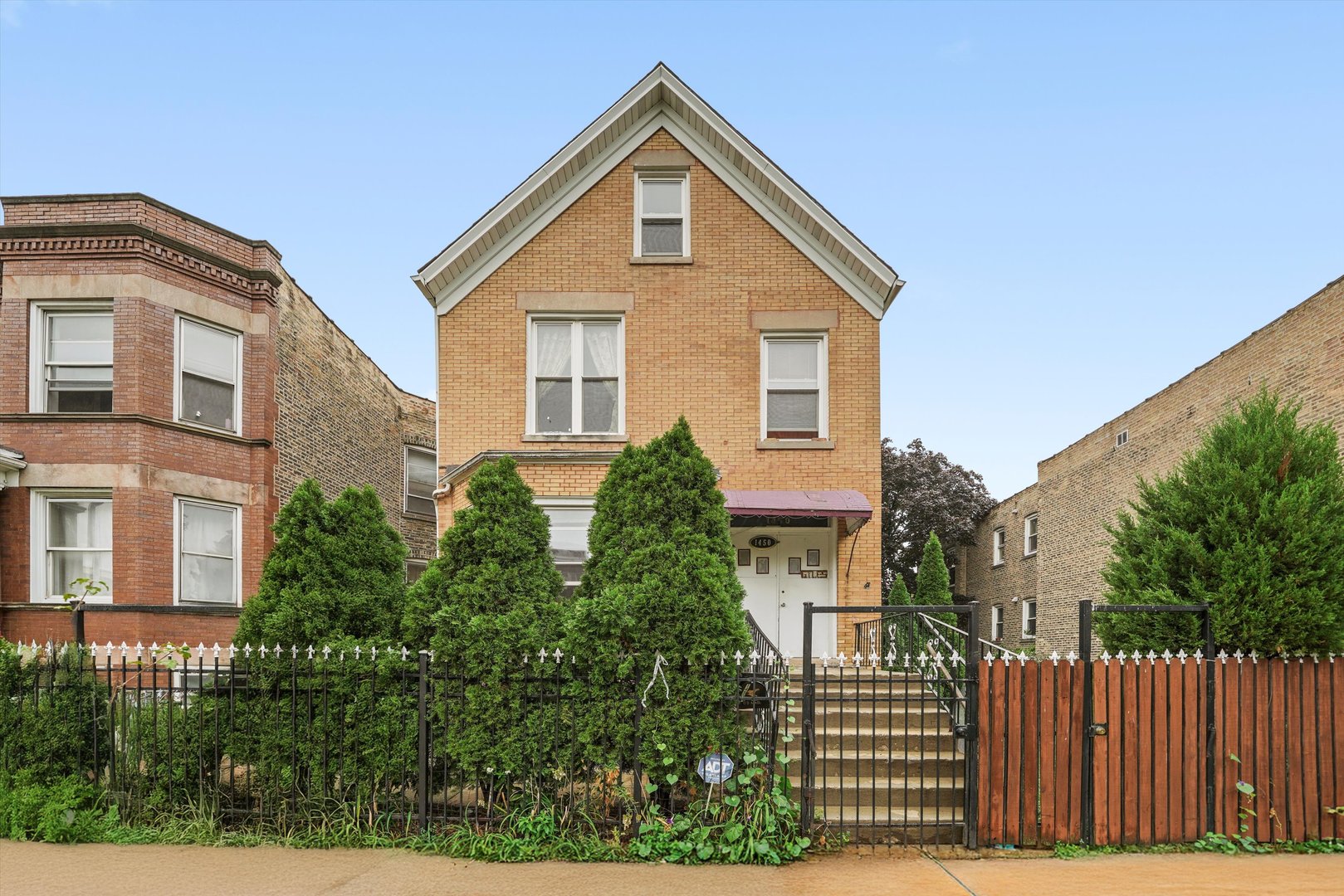1450 North Springfield Avenue Chicago, IL 60651 - Photo 2 of 46 a front view of a house with a yard