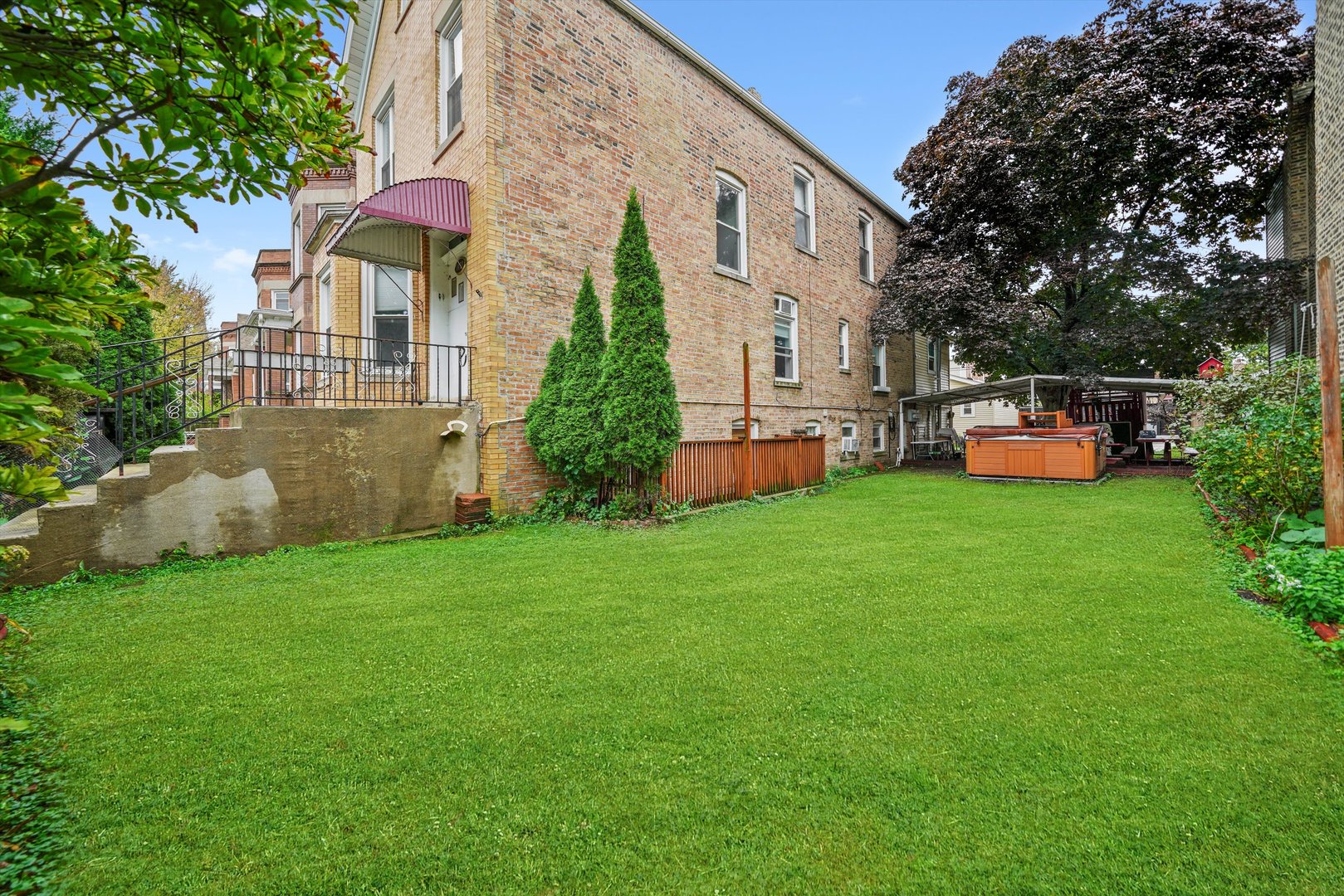 1450 North Springfield Avenue Chicago, IL 60651 - Photo 28 of 46 a front view of a house with a garden and plants