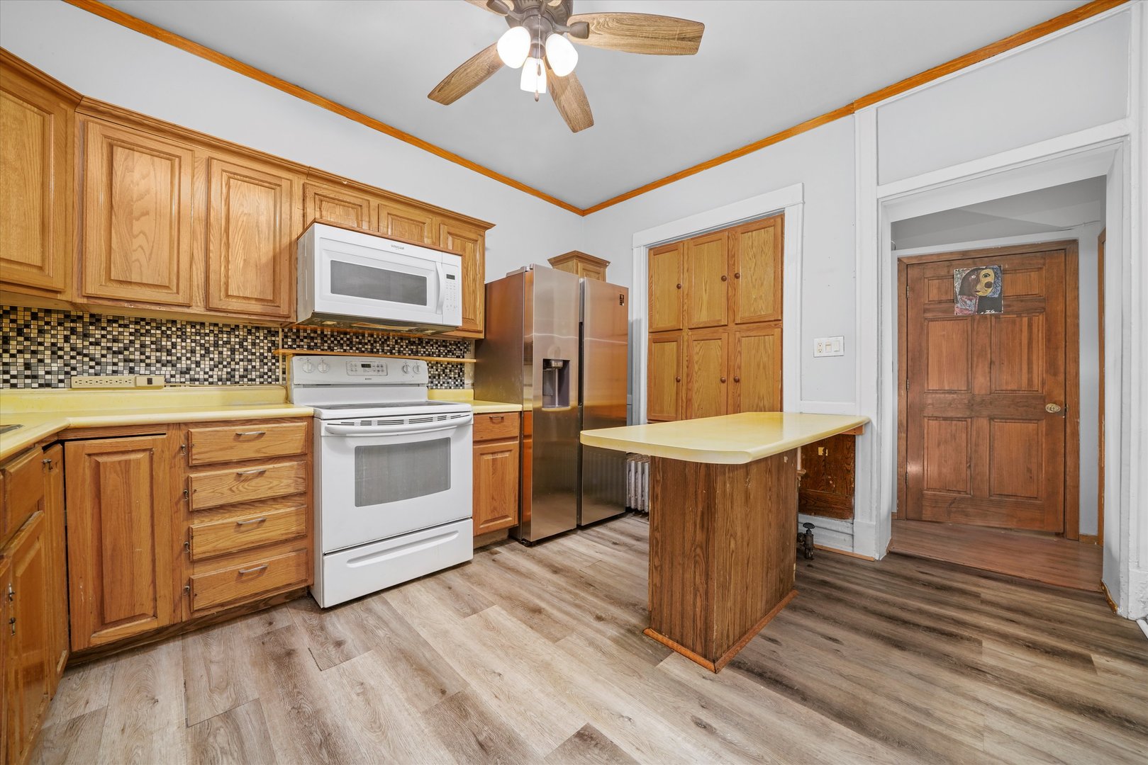1450 North Springfield Avenue Chicago, IL 60651 - Photo 3 of 46 a kitchen with stainless steel appliances granite countertop a stove and a refrigerator