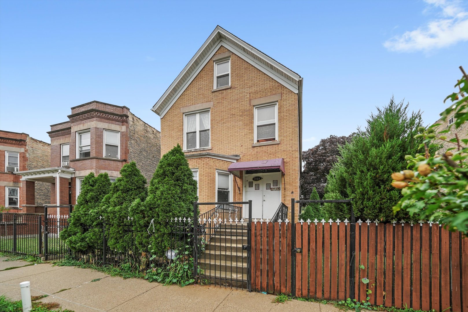 1450 North Springfield Avenue Chicago, IL 60651 - Photo 38 of 46 a front view of a house with a garden