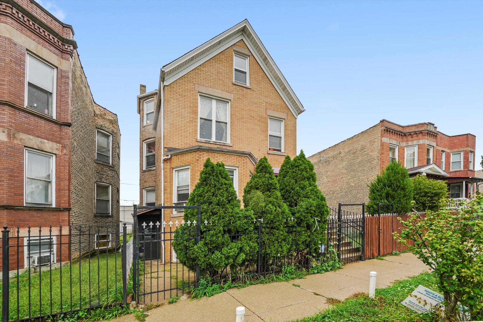 1450 North Springfield Avenue Chicago, IL 60651 - Photo 39 of 46 a front view of a house with a yard