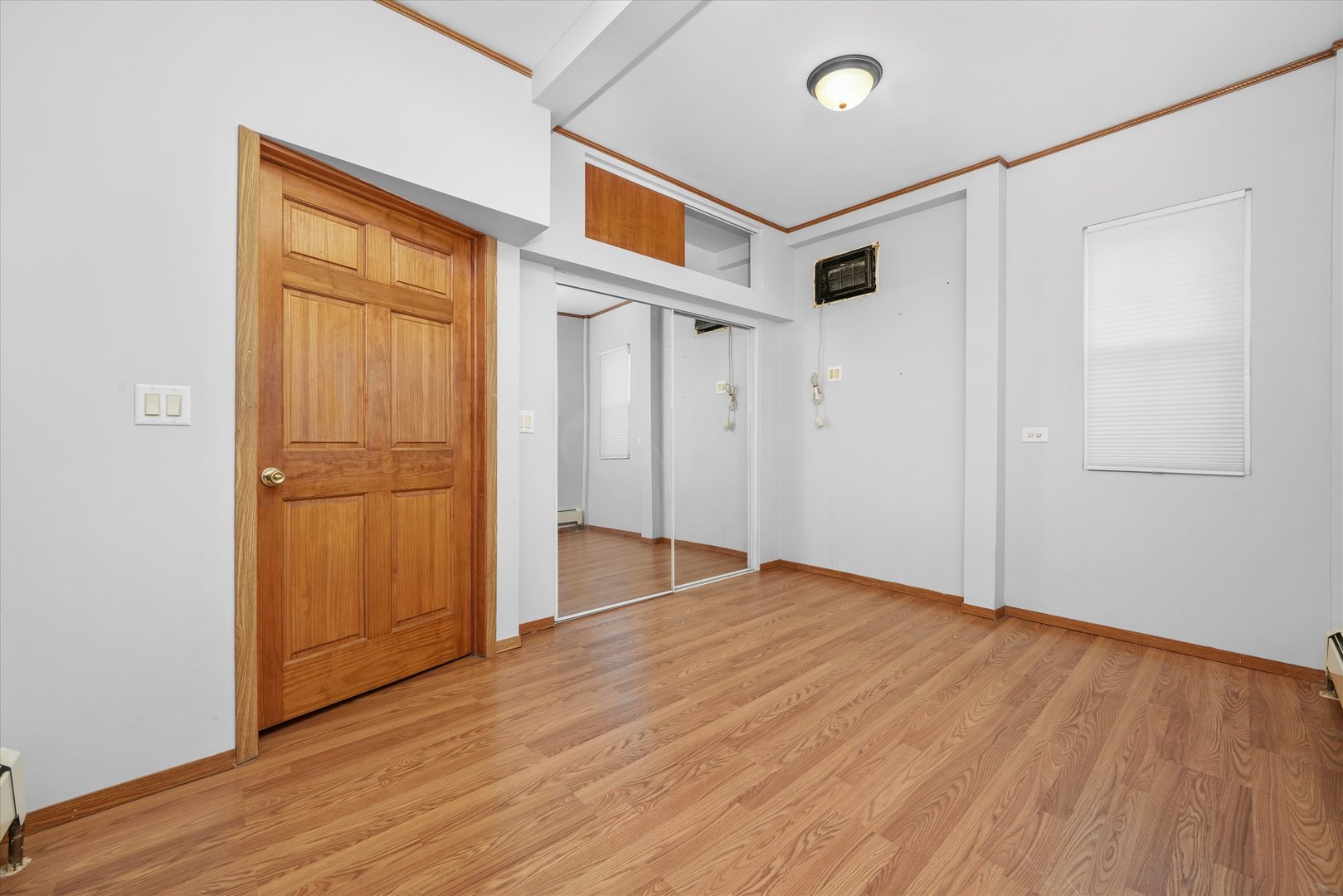 1450 North Springfield Avenue Chicago, IL 60651 - Photo 8 of 46 a view of an empty room with wooden floor and a window