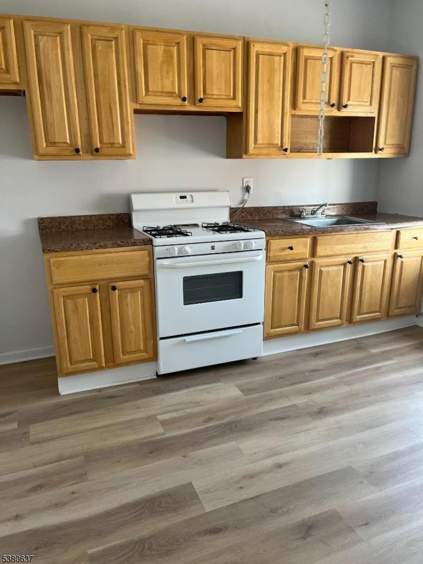 304 Morris Avenue Elizabeth, NJ 07208 - Photo 5 of 9 a kitchen with stainless steel appliances granite countertop a stove and a sink
