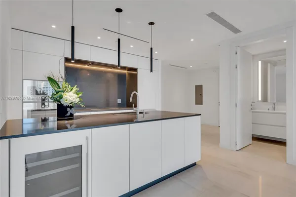 a view of kitchen with stainless steel appliances kitchen island wooden floor and window