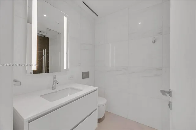 a bathroom with a shower and a glass door