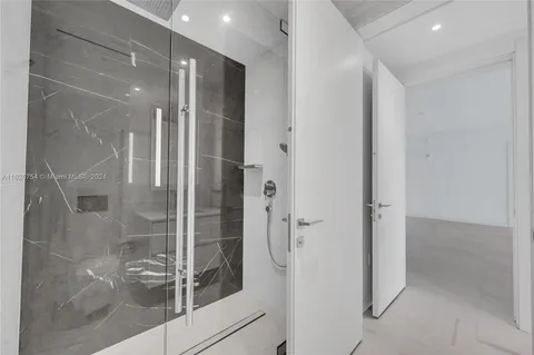 a kitchen with kitchen island a sink and white cabinets