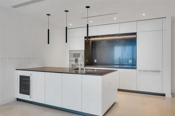 a kitchen with stainless steel appliances a stove and a microwave