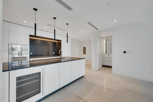 a kitchen with granite countertop a sink and a stove