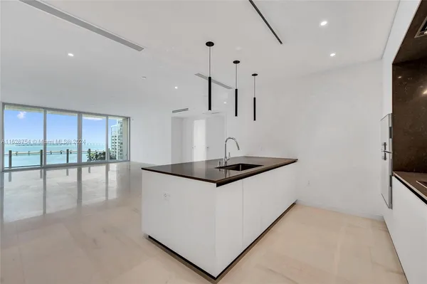 a kitchen with granite countertop a stove and a sink