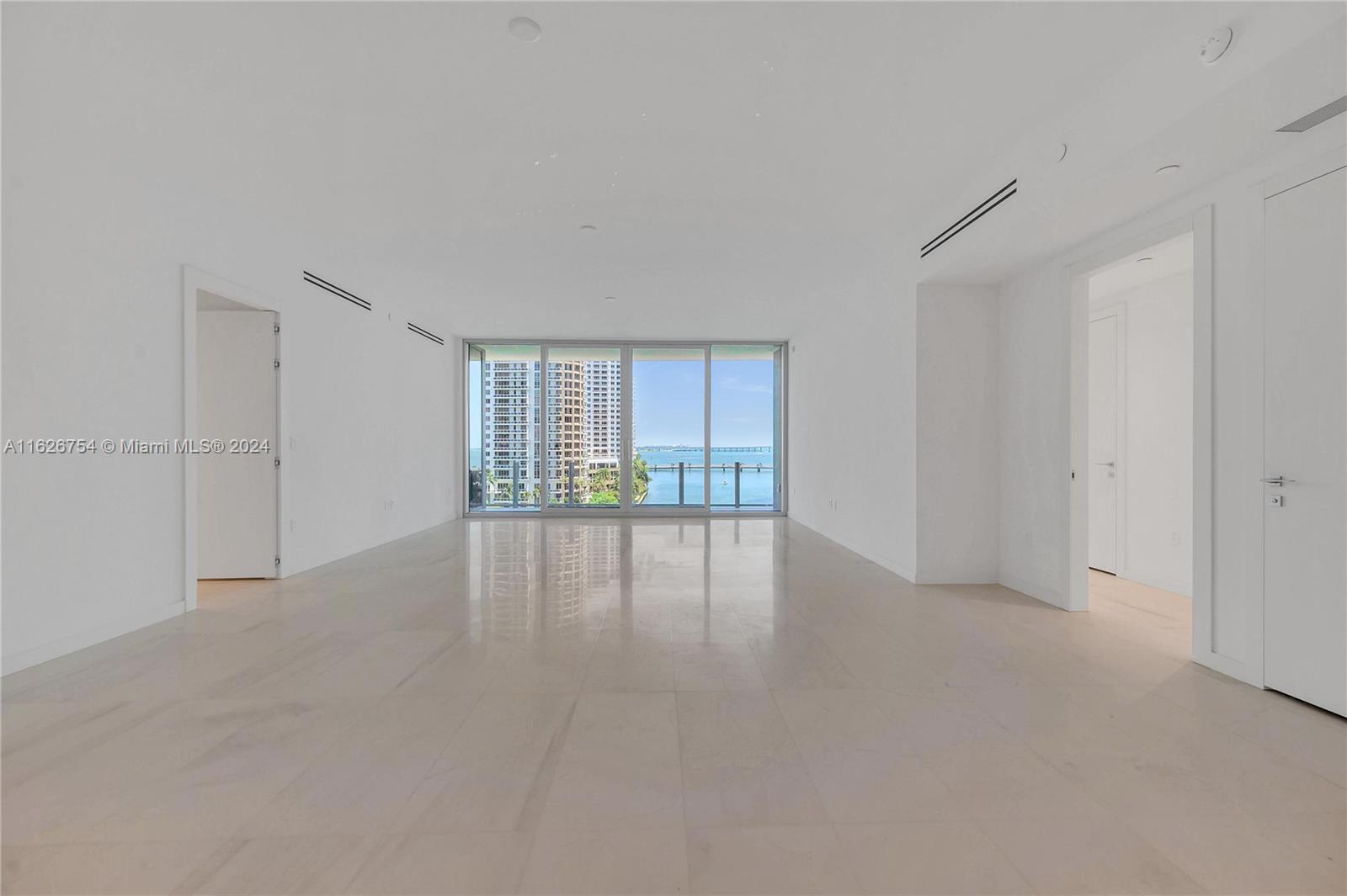 300 Biscayne Blvd Way, Unit 703 Miami, FL 33131 - Photo 10 of 27 a view of an empty room with wooden floor and a window
