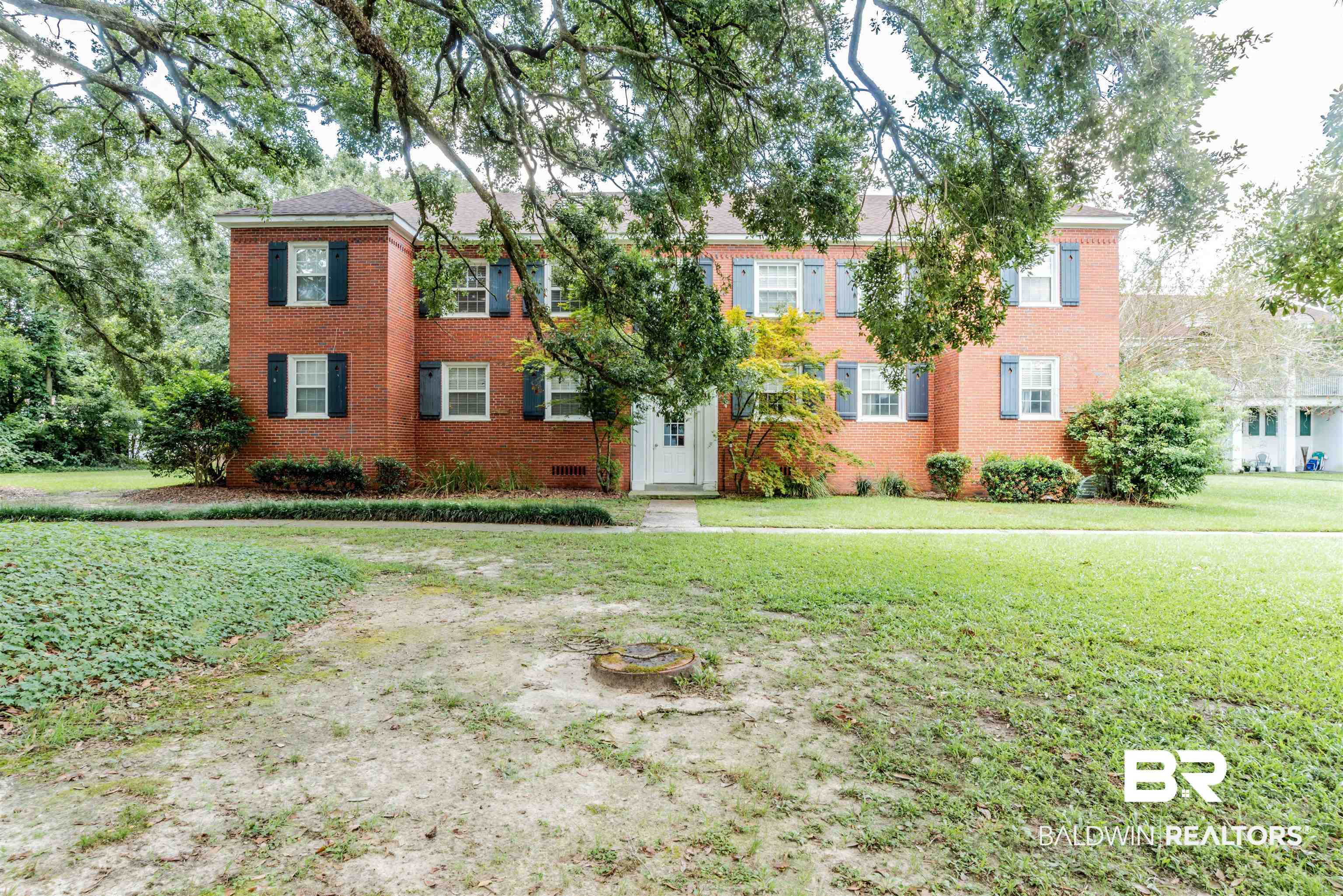 214 Upham Street, Unit 7C Mobile, AL 36607 - Photo 19 of 32 Colonial home featuring a front lawn and brick siding