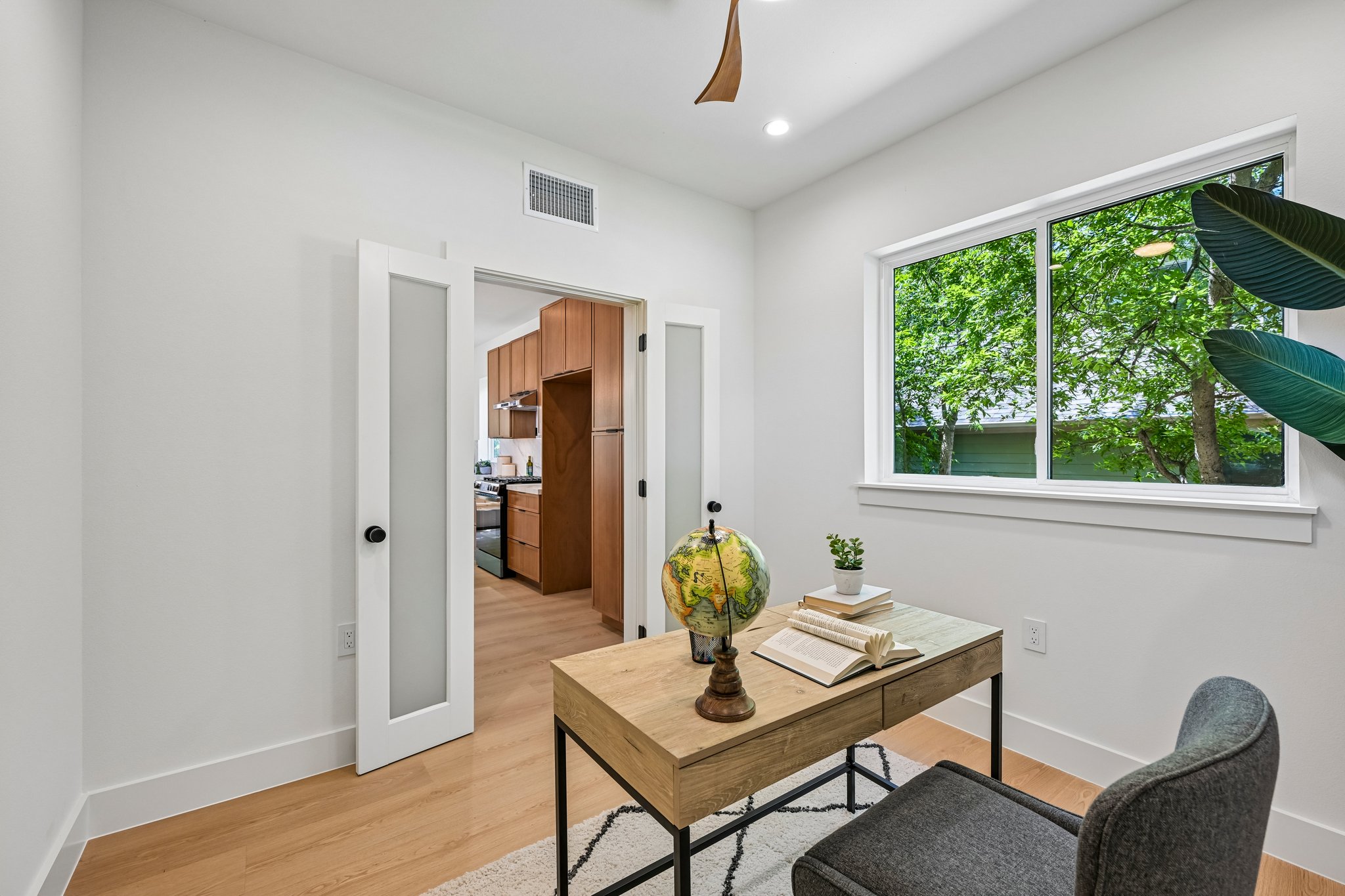 513 West Odell Street, Unit B Austin, TX 78752 - Photo 25 of 38 An inviting study with frosted french doors and a large window offers a serene workspace. If no home office is needed, this room could be a formal dining.