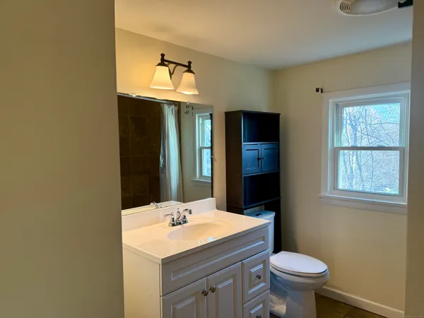 a bathroom with a toilet and shower