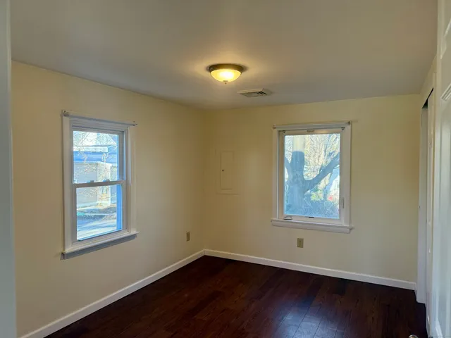 a view of room with wooden floor