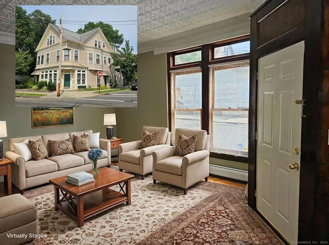 a living room with furniture large windows and a rug