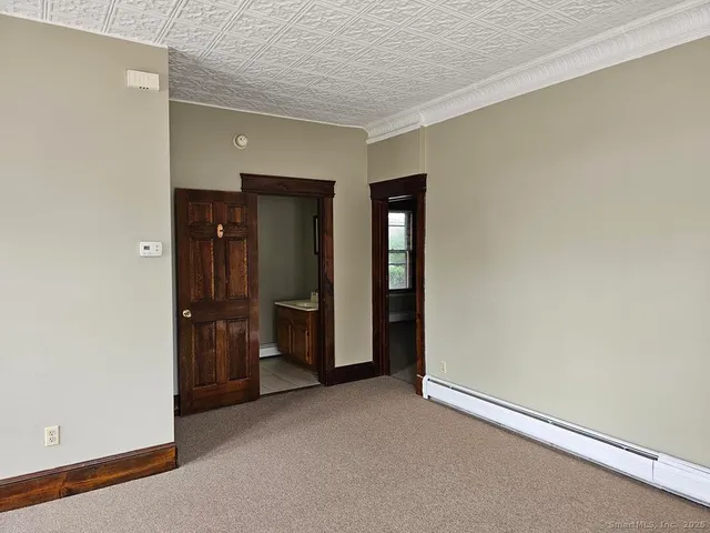 an empty room with closet and wooden floor