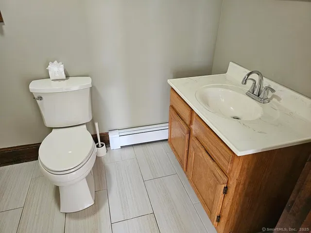 a bathroom with a sink a toilet and a mirror