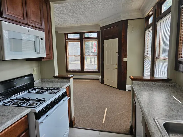 a kitchen with granite countertop a stove and a sink
