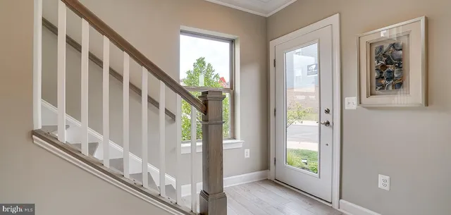 a view of entryway with wooden floor and stairs