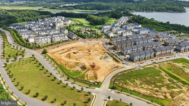 an aerial view of a house with a yard and lake view