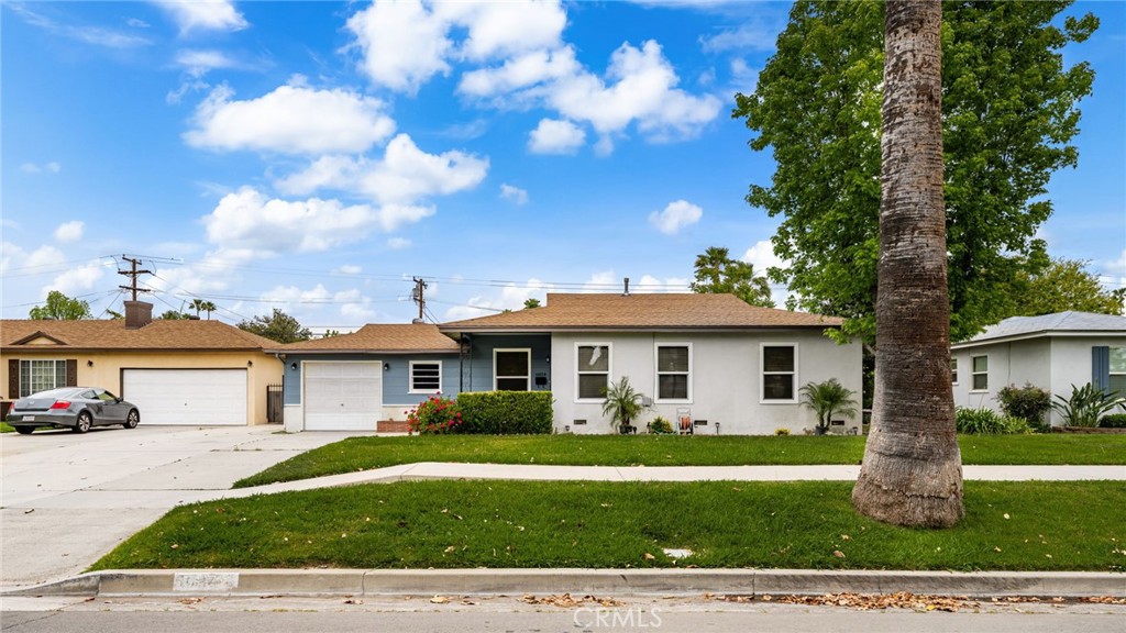 6934 Palomar Way Riverside, CA 92504 - Photo 1 of 1 a front view of a house with a garden
