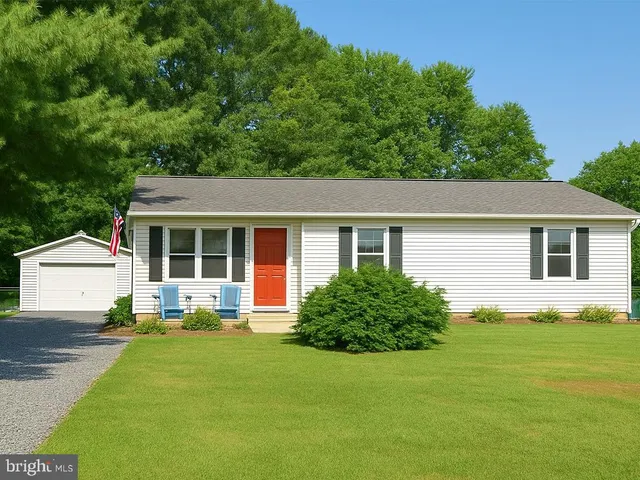 a front view of house with yard and green space