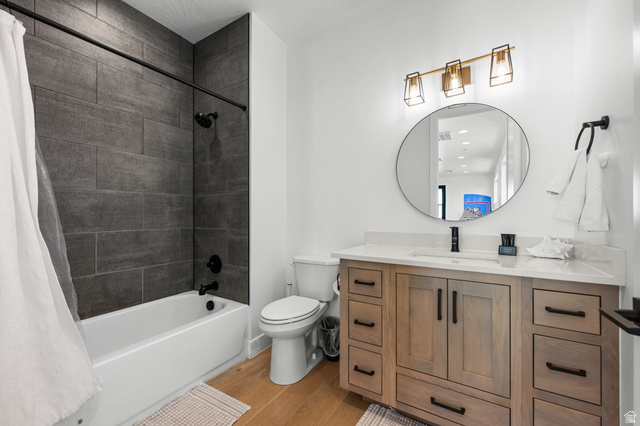 5354 Cyan Lane St. George, UT 84790 - Photo 15 of 45 Bathroom featuring vanity, light wood-style flooring, and shower / tub combo with curtain