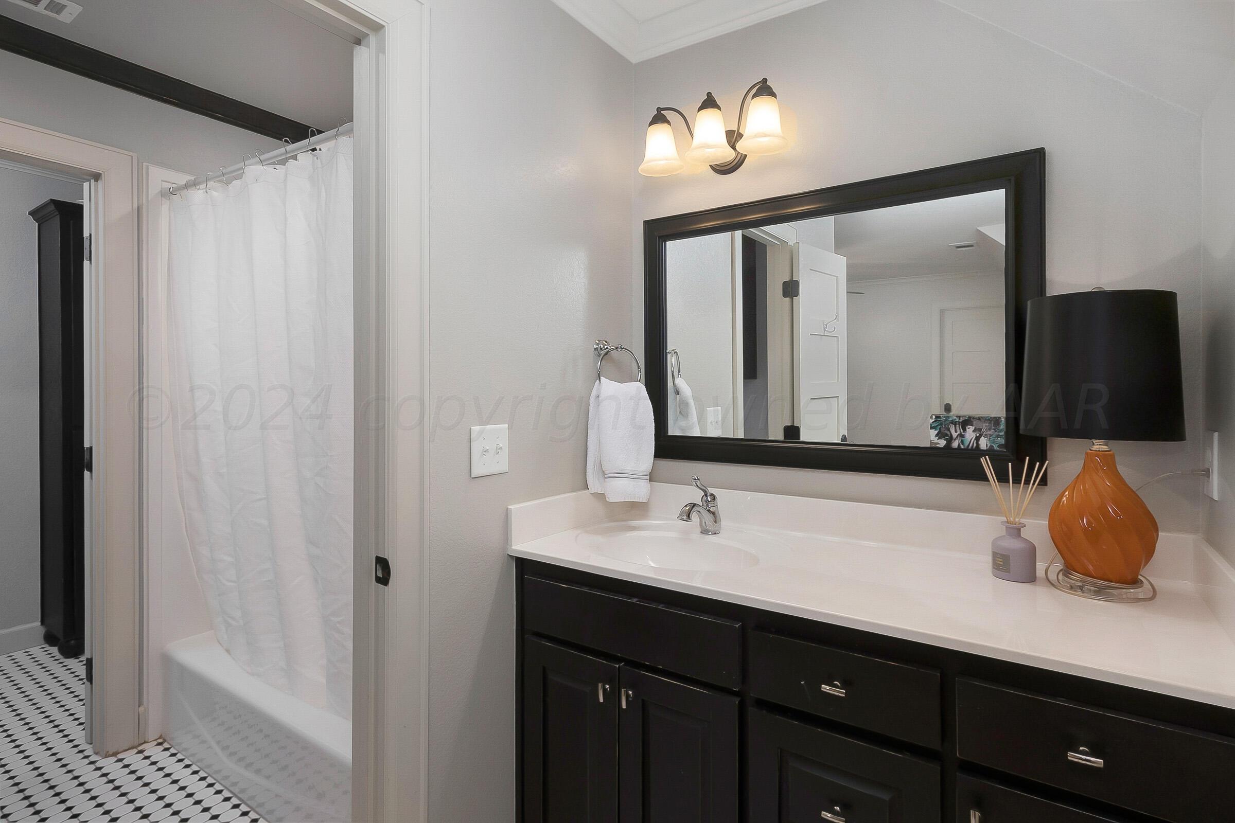 6107 Blue Sage Circle Amarillo, TX 79124 - Photo 60 of 79 a bathroom with a double vanity sink and mirror