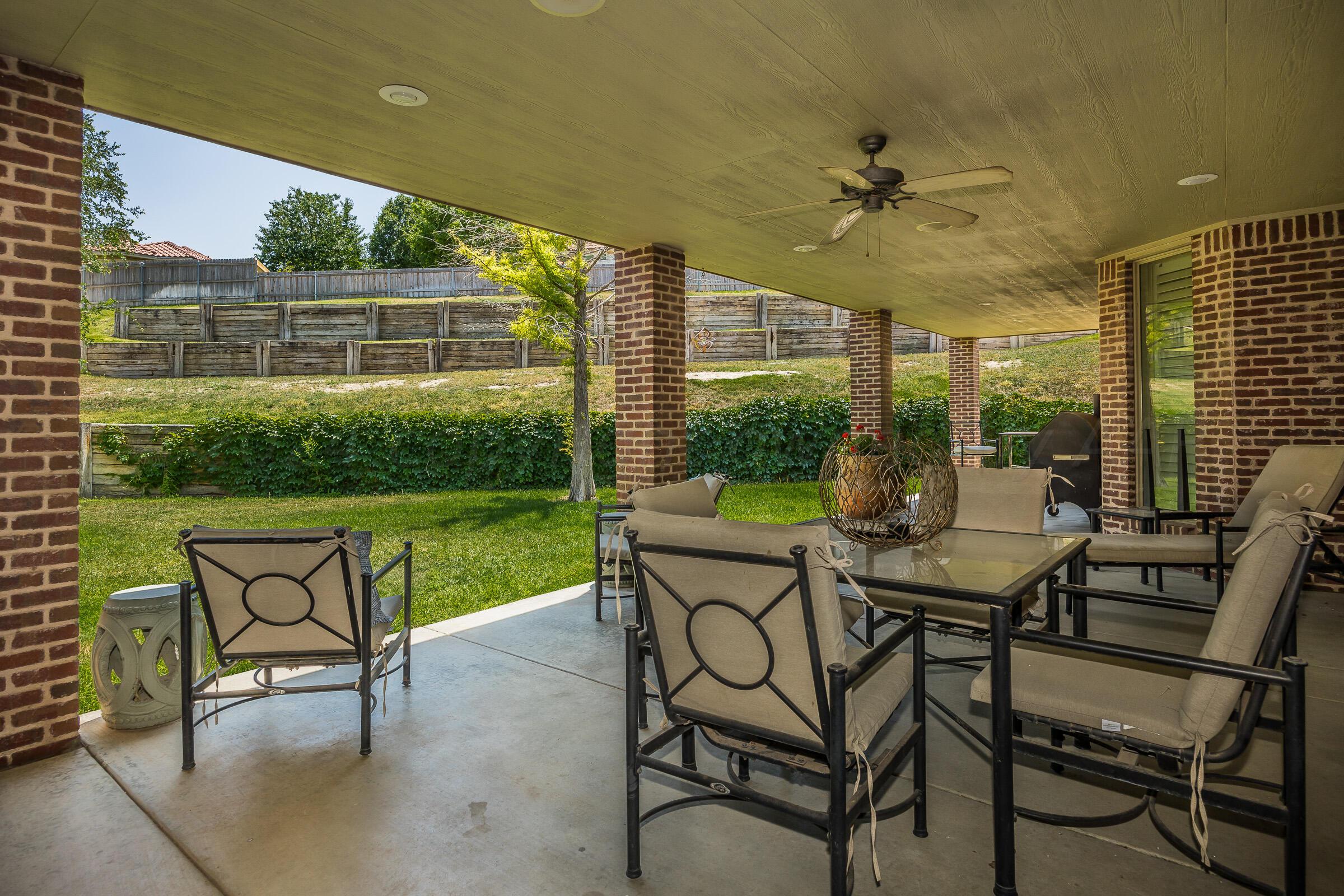 6107 Blue Sage Circle Amarillo, TX 79124 - Photo 77 of 79 a view of a patio with a table chairs and a backyard