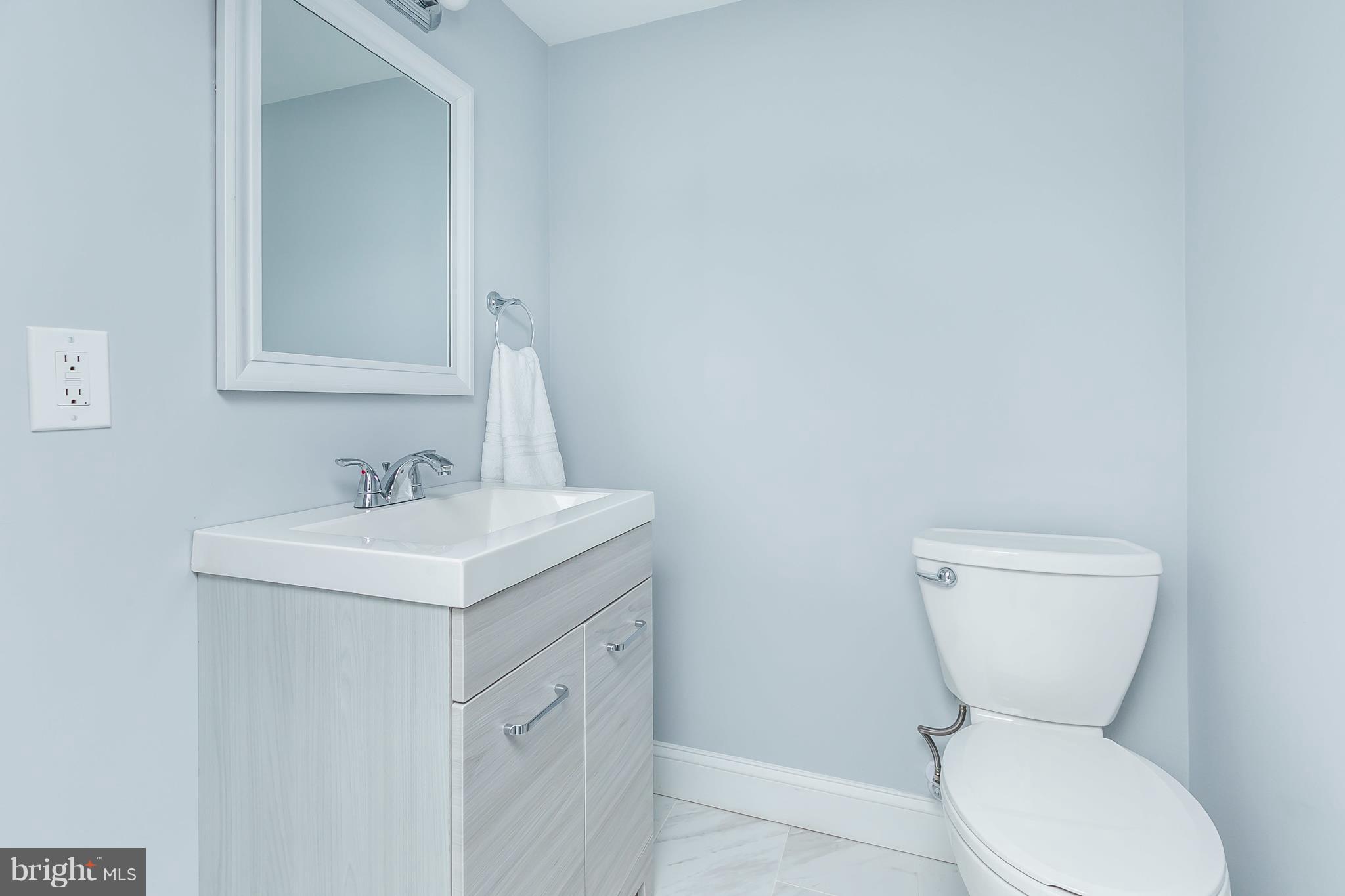 7808 Charlesmont Road Baltimore, MD 21222 - Photo 27 of 32 a bathroom with a toilet sink and mirror