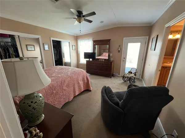 a bed room with furniture and a flat screen tv