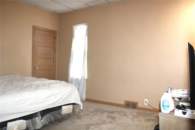 a bedroom with a bed and a lamp