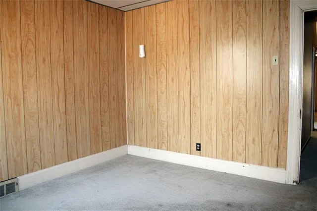 a view of an empty room with a wooden wall