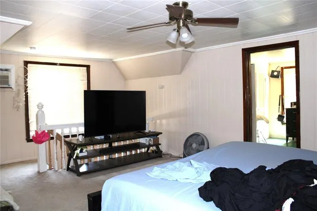 a bedroom with bed and tv