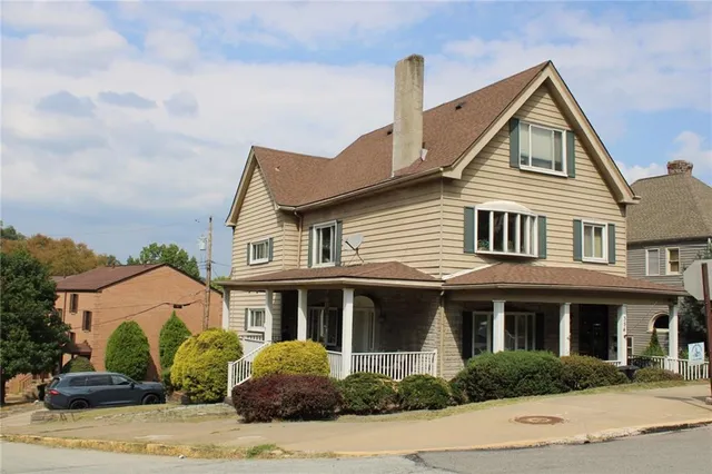 a front view of a house with a garden