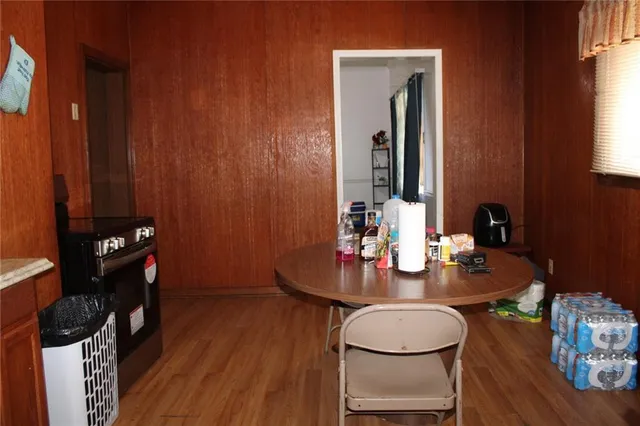 a dining room with furniture and wooden floor