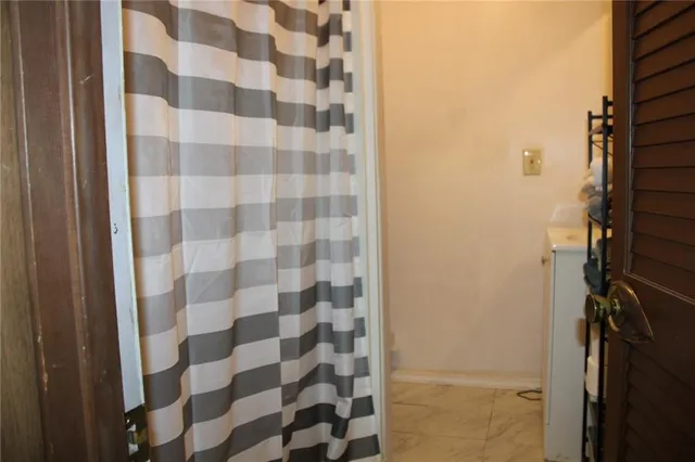 a bathroom with a shower and a sink