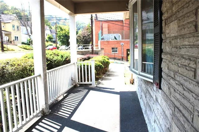 a view of a balcony with wooden floor