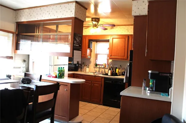a kitchen with a sink dining table and chairs