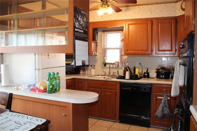 a kitchen with stainless steel appliances granite countertop a sink and a refrigerator