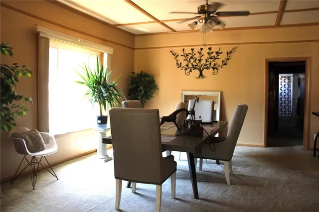 a dining room with furniture and window