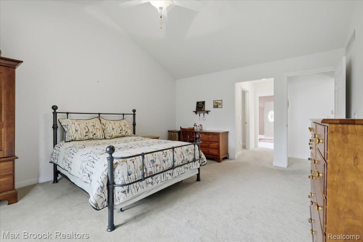 1731 Rico Road Commerce Township, MI 48382 - Photo 22 of 48 Vaulted ceiling, ceiling fan, neutral wall finishes, neutral carpet, and an open doorway