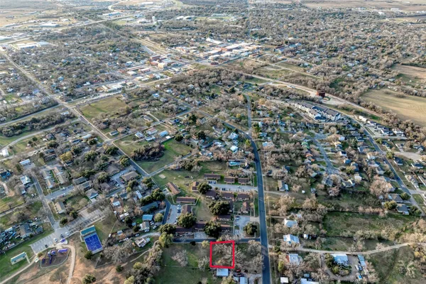 an aerial view of residential houses with city view