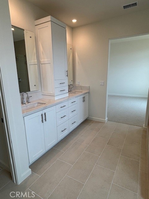 109 Escala Irvine, CA 92618 - Photo 9 of 12 a bathroom with a granite countertop sink a mirror and a