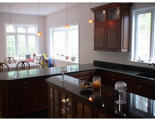 23 Bayns Hill Road Boxford, MA 01921 - Photo 8 of 11 a kitchen with granite countertop a sink a stove and cabinets