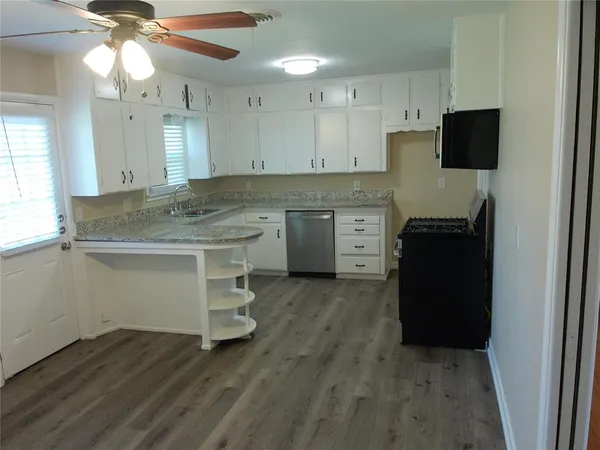 a kitchen with a refrigerator and a sink